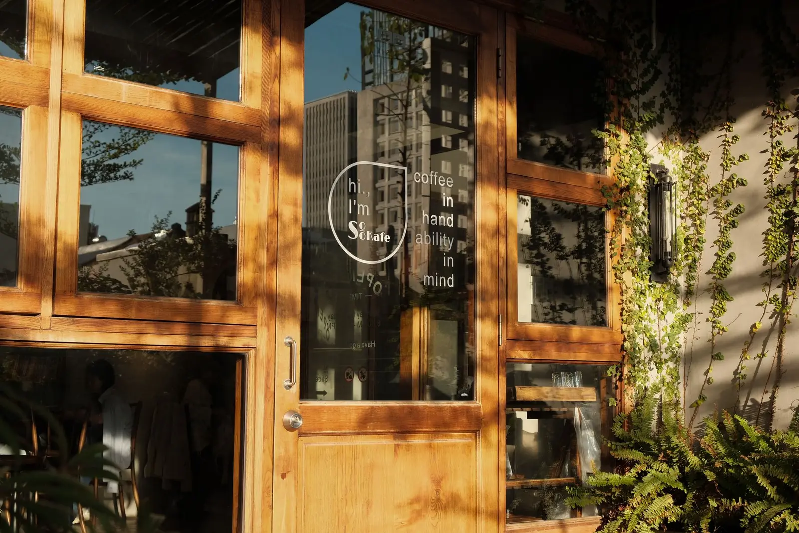 Cafe entrance with a wooden door and windows. SEO Company work for a US small business