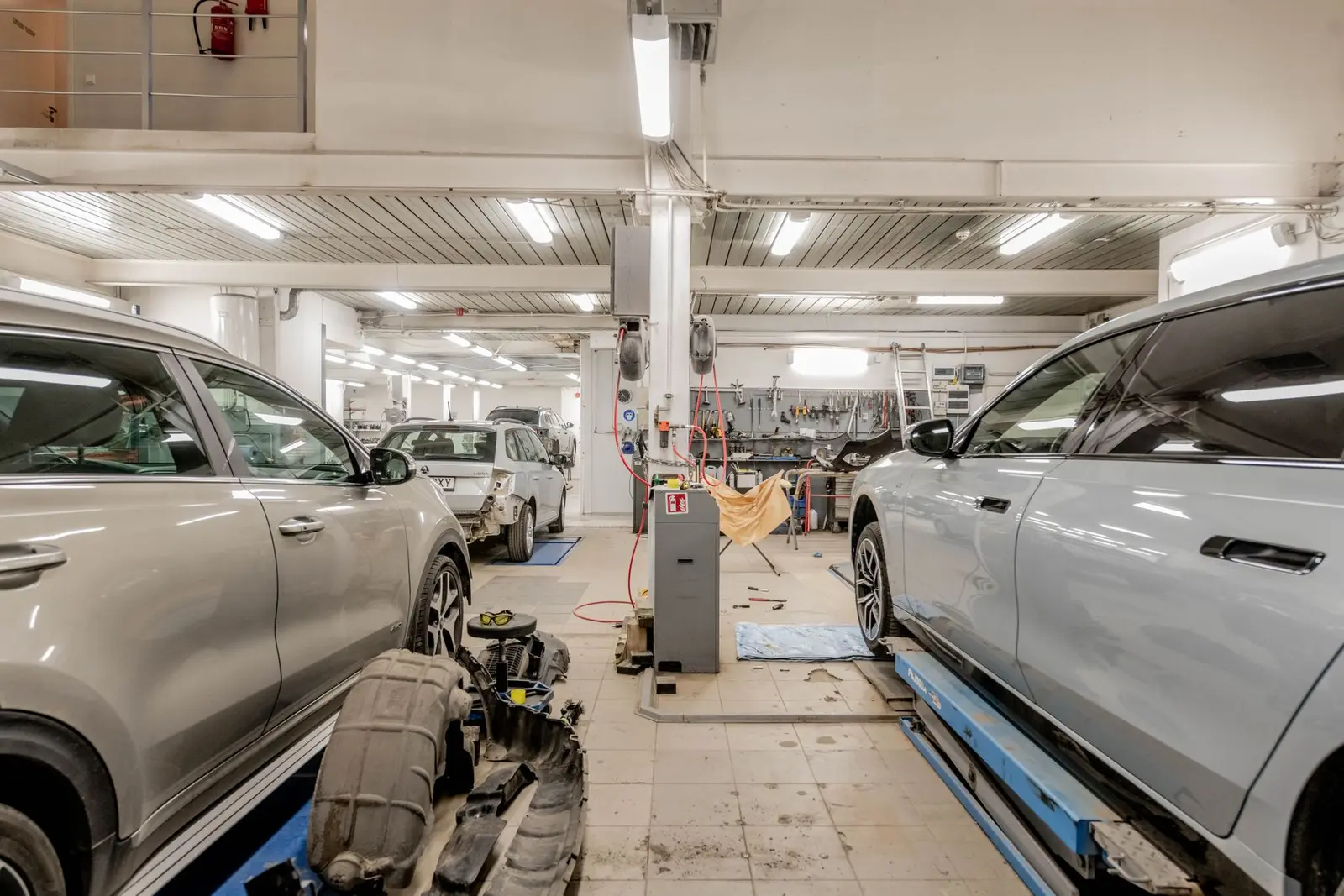 Cars being serviced inside an auto repair shop. Auto repair marketing for status calls and inspections