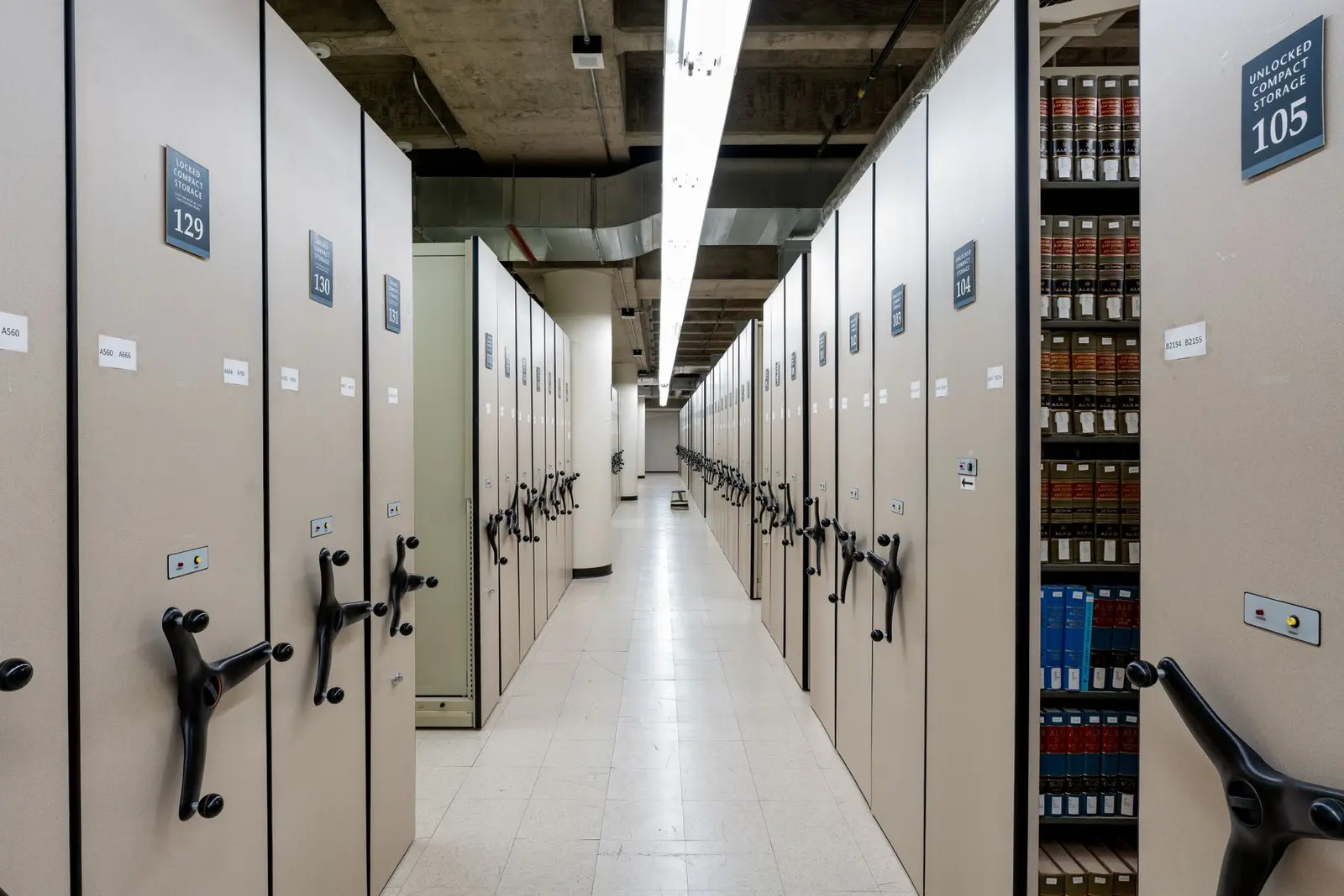Compact library shelving in a quiet archive. Marketing and intake for small and mid-size law firms