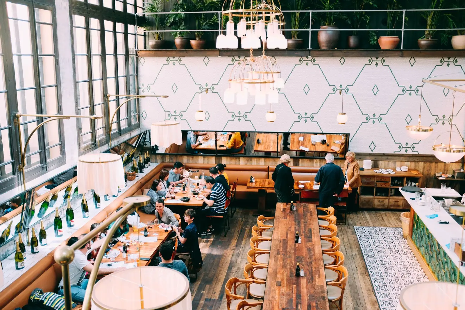 Restaurant dining room with wooden tables and guests. Restaurant marketing when the phone rings during service
