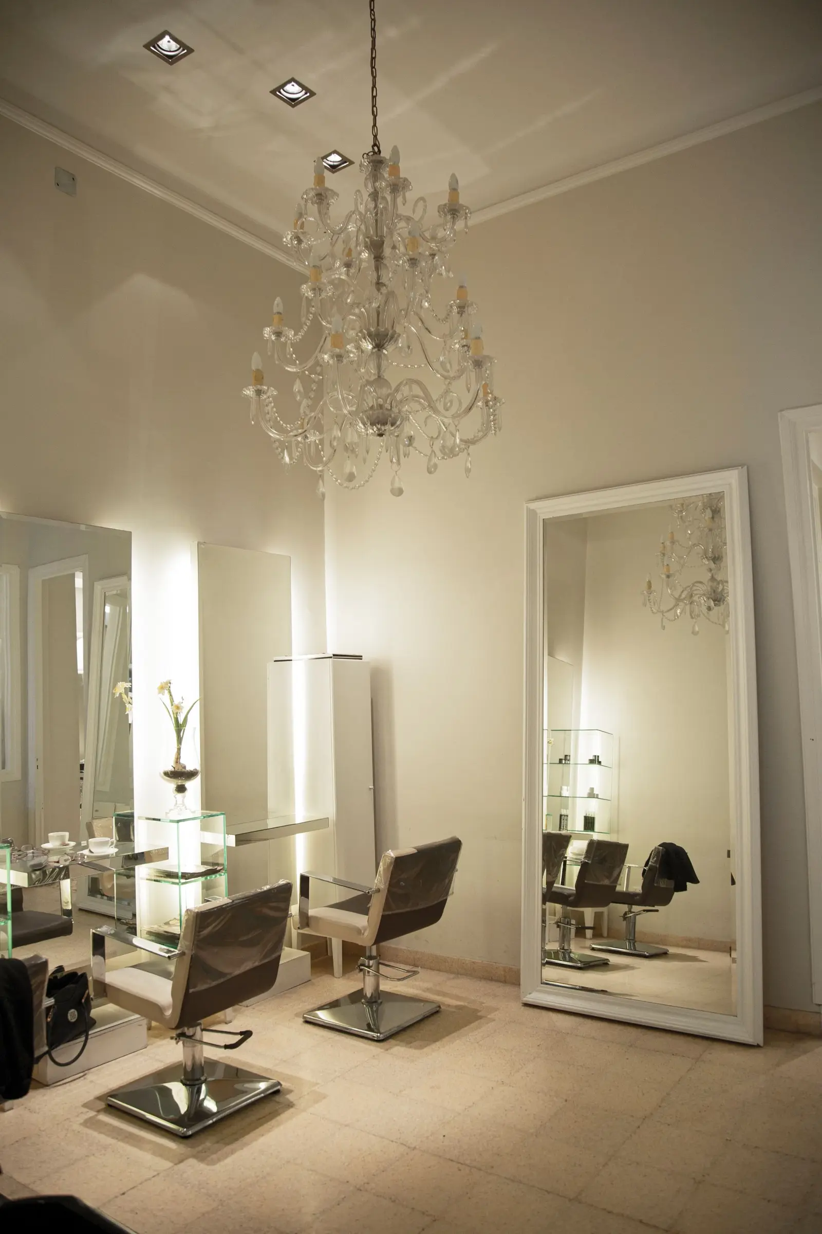 Modern salon interior with mirrors, chairs, and a chandelier. Salon marketing built around the appointment book