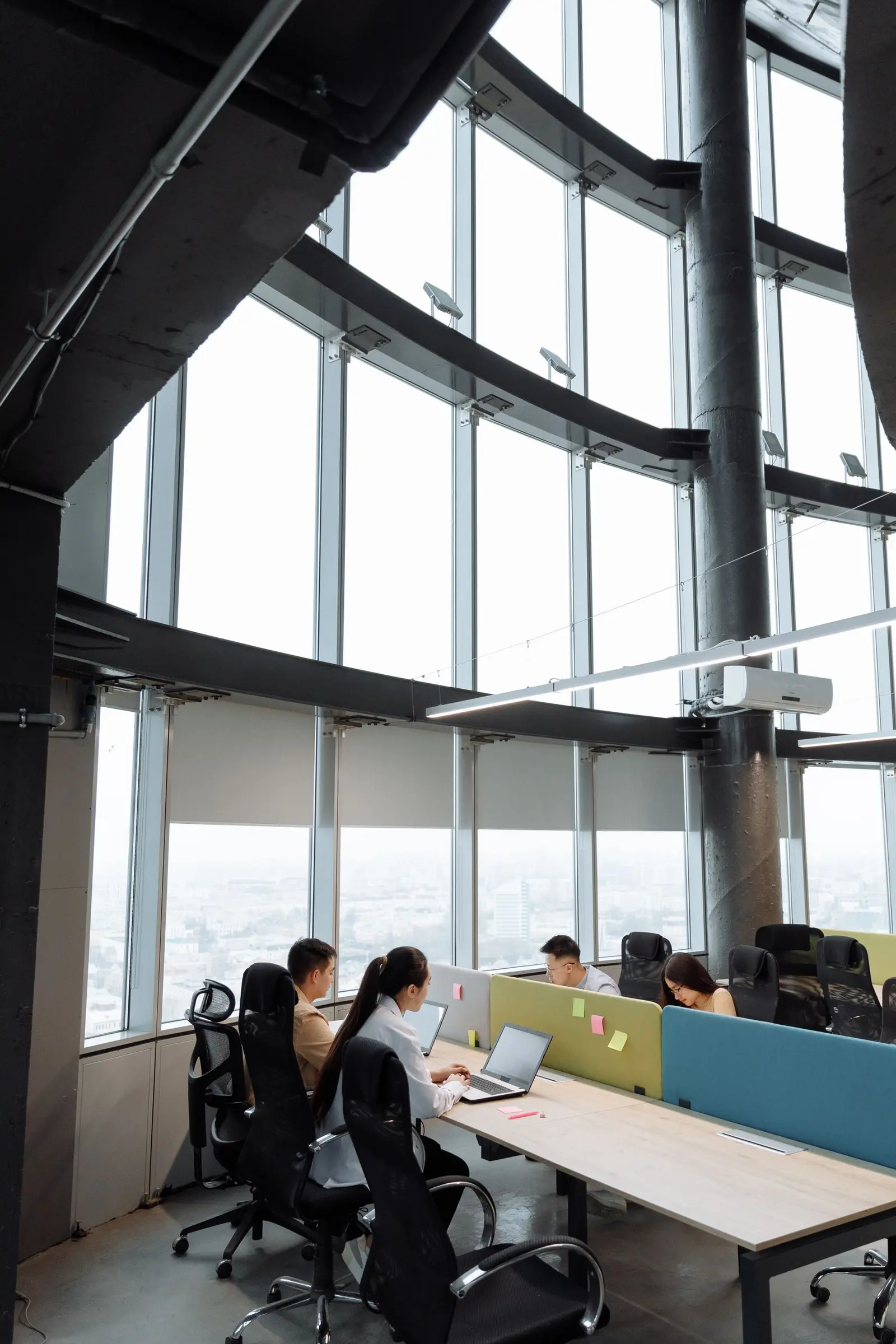 People working at computers in an office. Meta Ads Company work for a US small business
